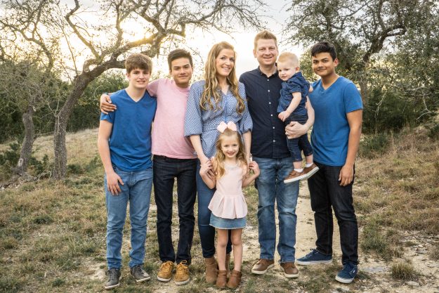 Family picture surrounded by trees.