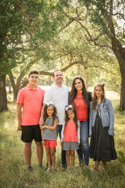 Group family picture in park.